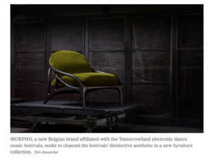 A lounge chair with a sculptural dark wood frame and moss green cushions.