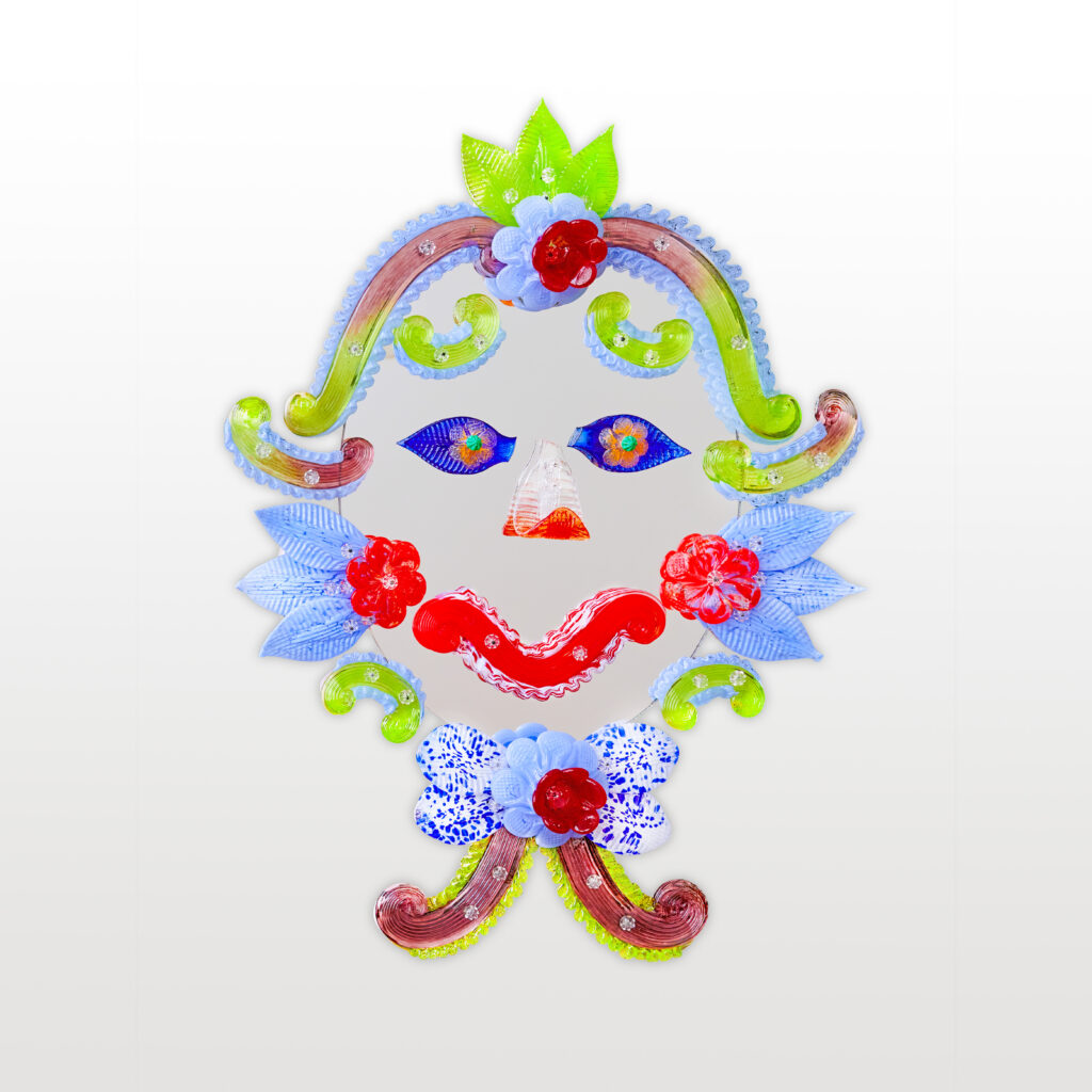 An oval mirror, set with other mirrored pieces so it looks like a face