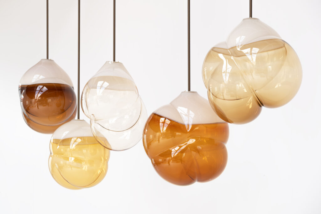 five cloud-shaped glass pendant lamps in shades of brown